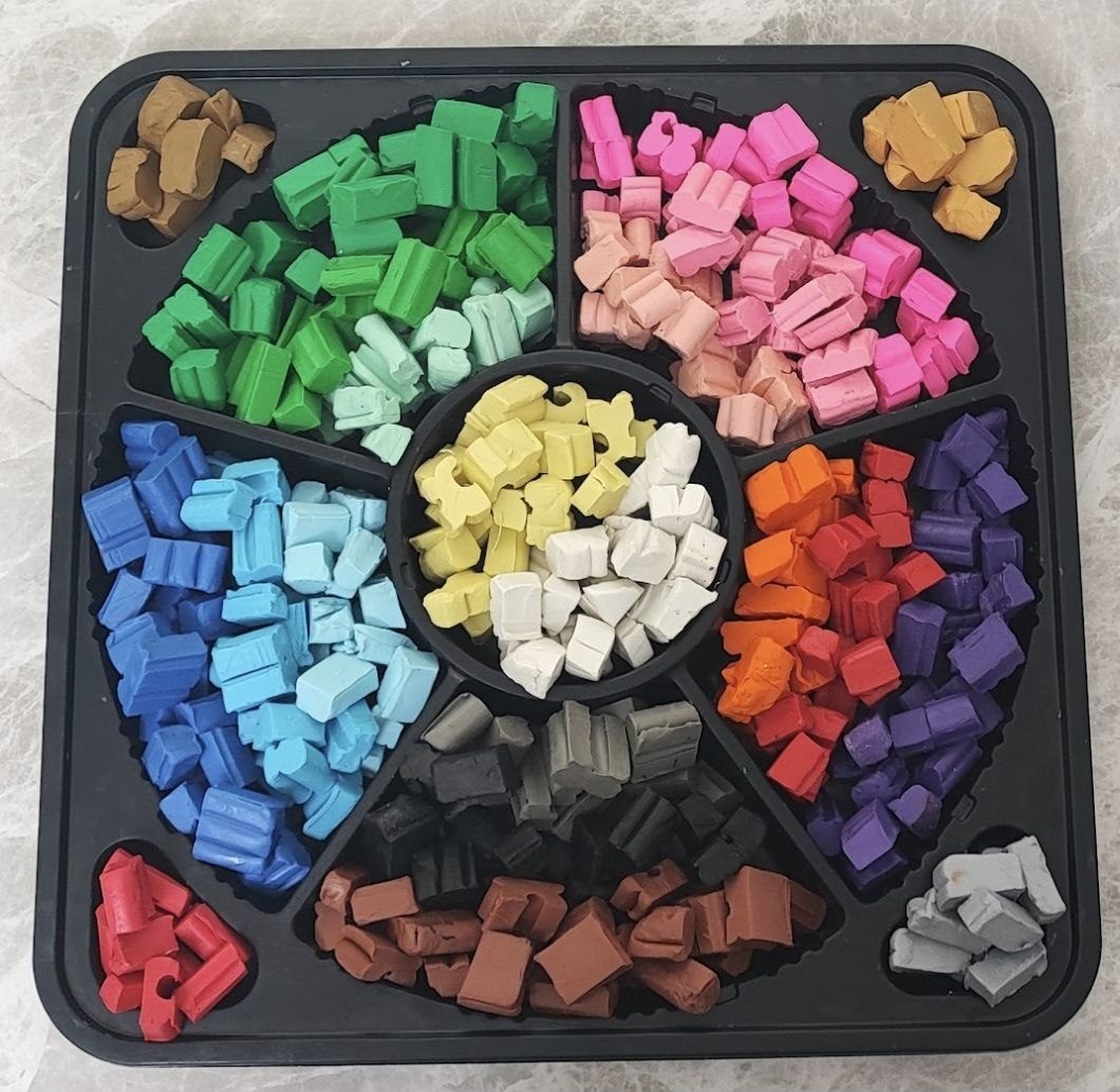 Tray of recycled crayon pieces sorted by color